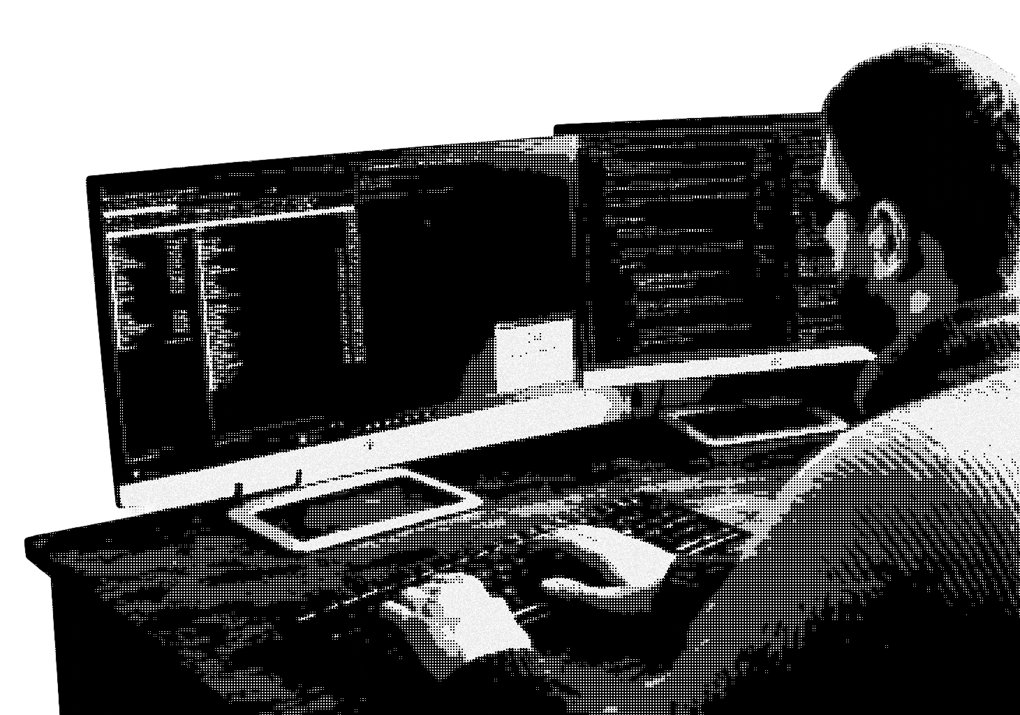 Developer working at multi-monitor coding setup